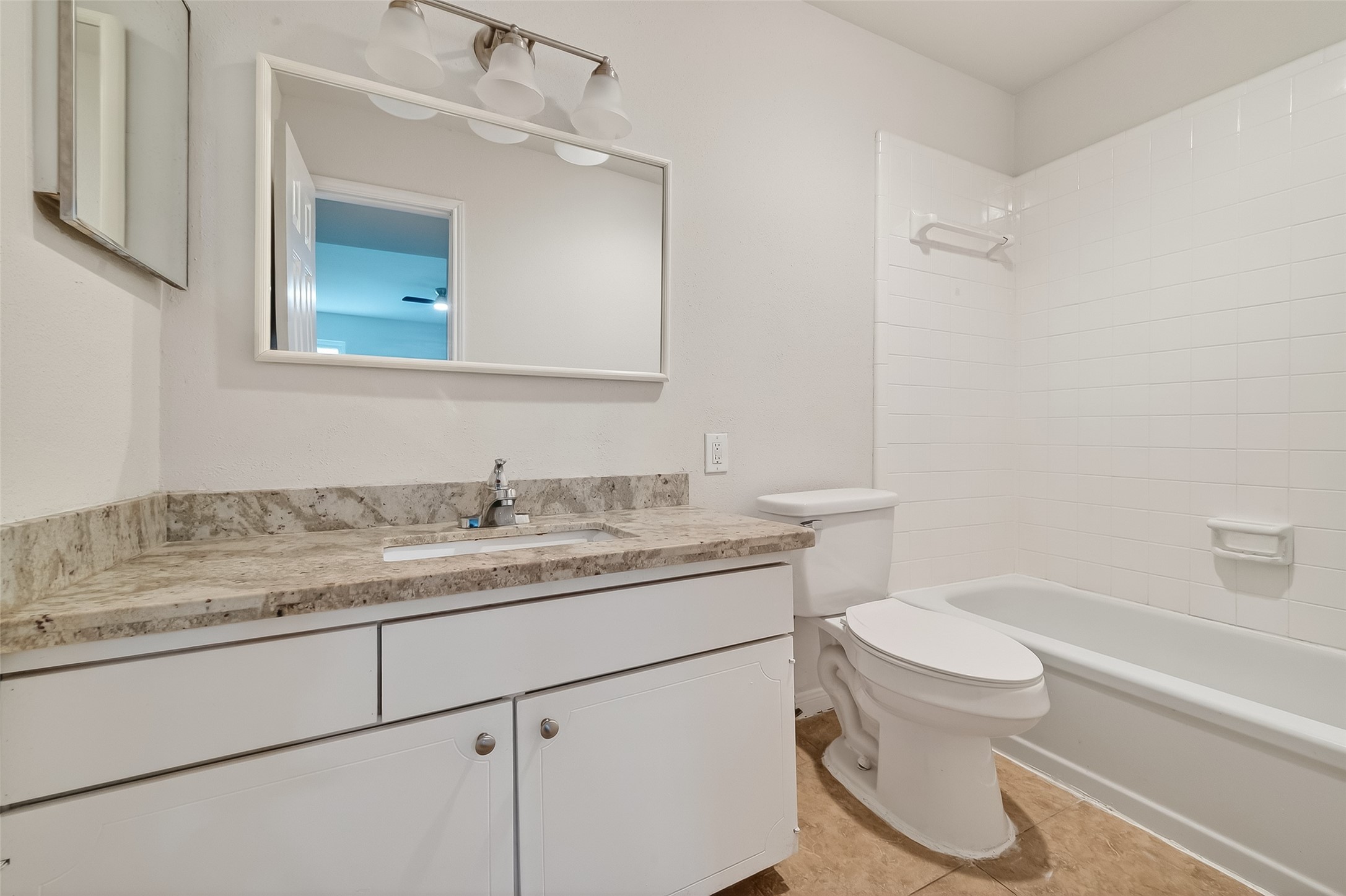 811 Threadneedle Street, Unit 258 Houston, TX 77079 - Photo 30 of 39 a bathroom with a granite countertop sink mirror vanity and toilet