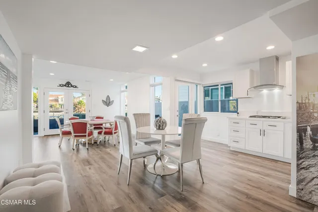 a dining room with furniture and wooden floor