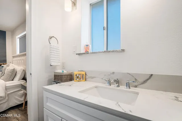 a picture of a room with a white wall and a large window