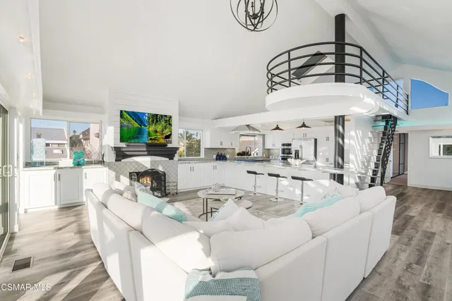 a room with stainless steel appliances kitchen island granite countertop a sink and cabinets