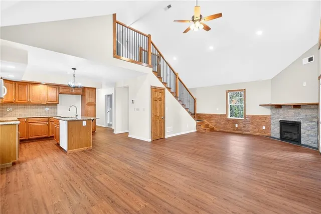 a living room with fireplace furniture and a wooden floor