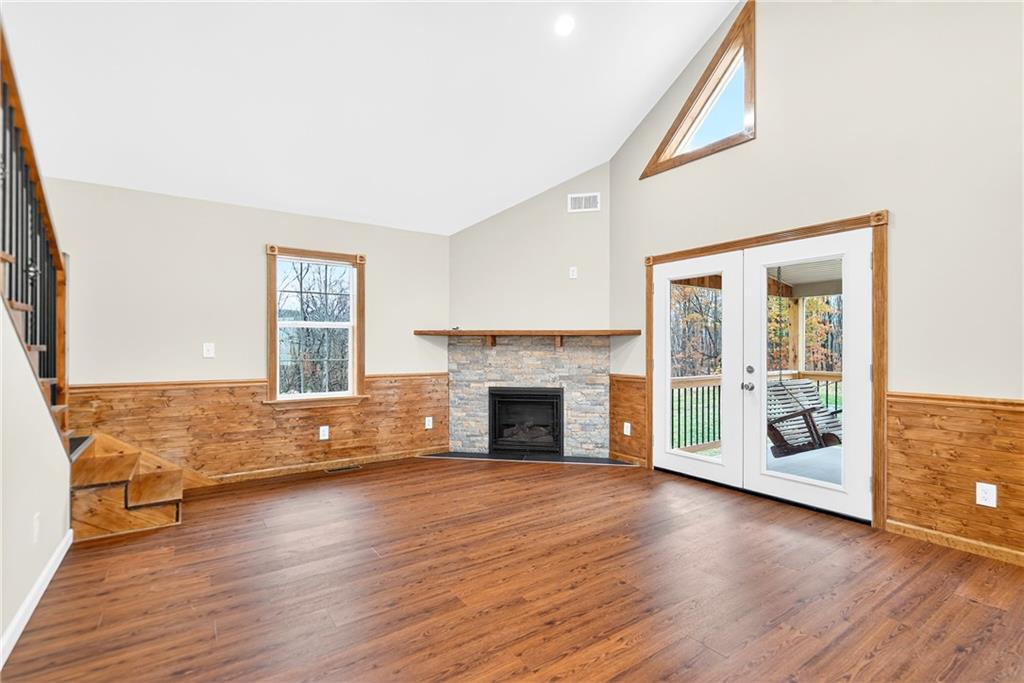 524 Sawmill Road Dawson, PA 15428 - Photo 17 of 50 an empty room with wooden floor fireplace and windows