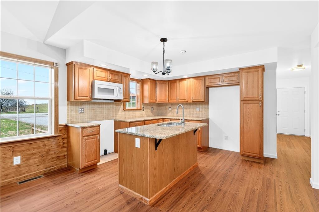 524 Sawmill Road Dawson, PA 15428 - Photo 21 of 50 a kitchen with stainless steel appliances granite countertop a stove and a wooden floors