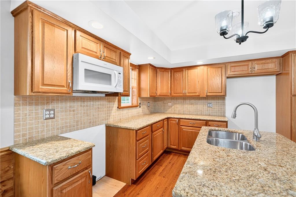 524 Sawmill Road Dawson, PA 15428 - Photo 23 of 50 a kitchen with kitchen island granite countertop a sink stainless steel appliances and cabinets