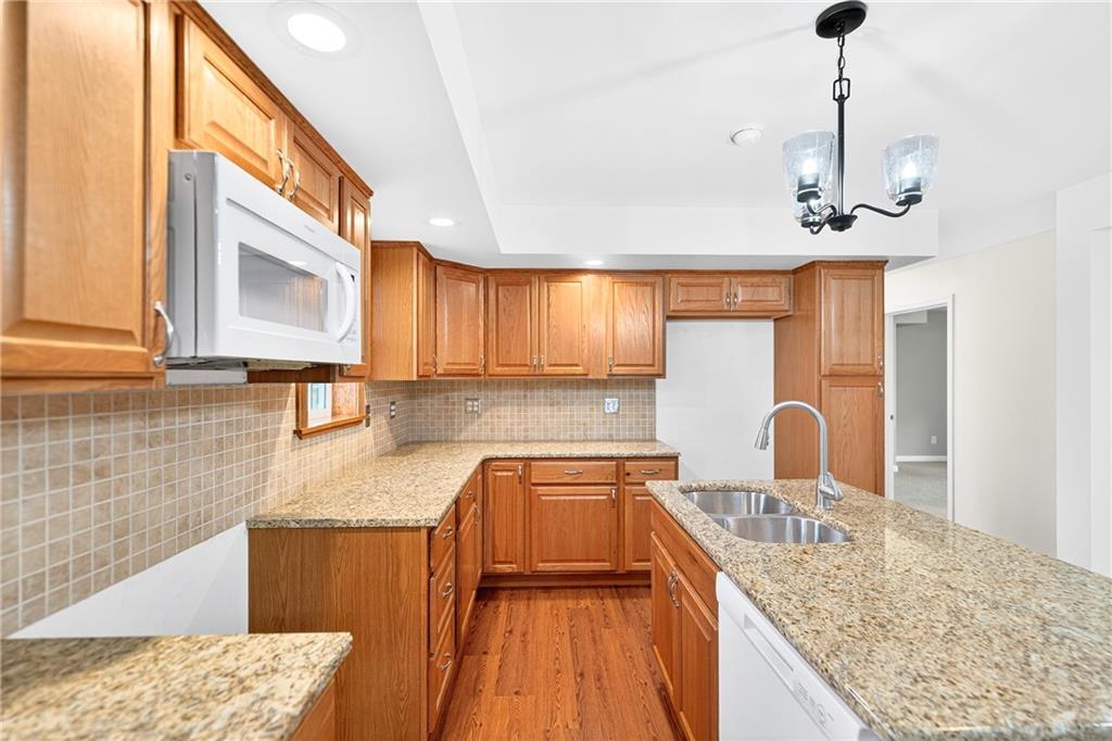 524 Sawmill Road Dawson, PA 15428 - Photo 25 of 50 a kitchen with granite countertop a sink a counter space appliances and cabinets