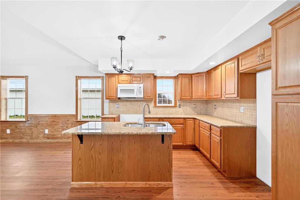 524 Sawmill Road Dawson, PA 15428 - Photo 28 of 50 a kitchen with stainless steel appliances granite countertop a sink stove and wooden cabinets