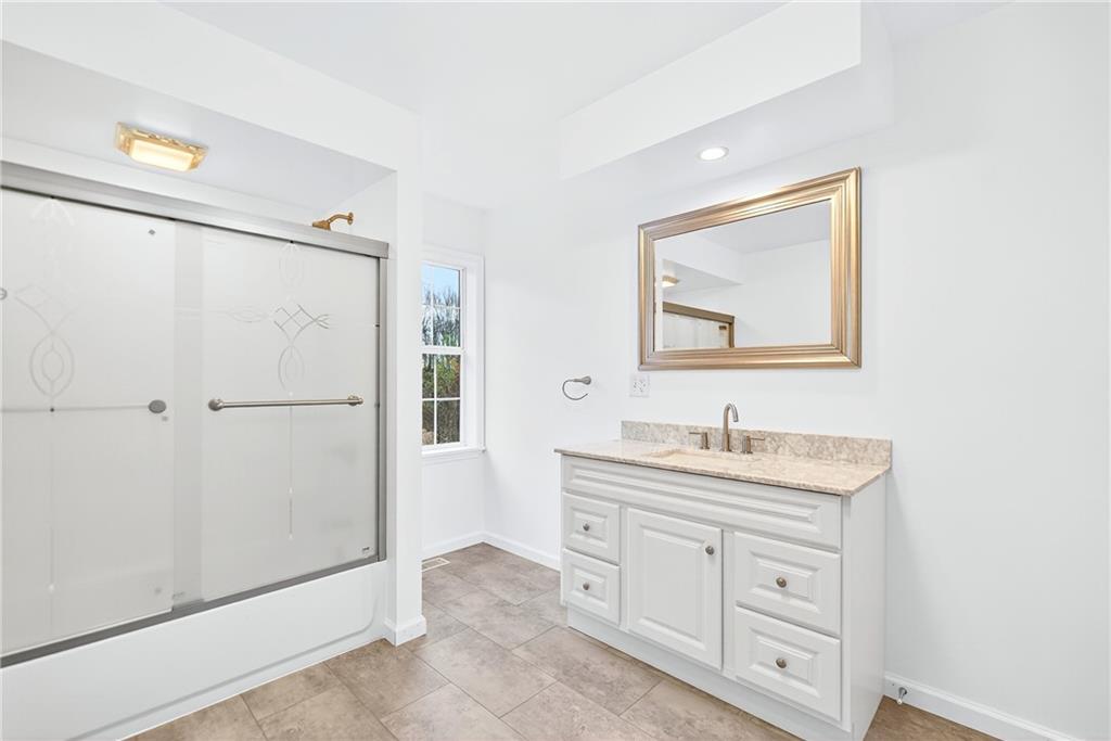 524 Sawmill Road Dawson, PA 15428 - Photo 30 of 50 a bathroom with a double vanity sink a toilet a mirror and