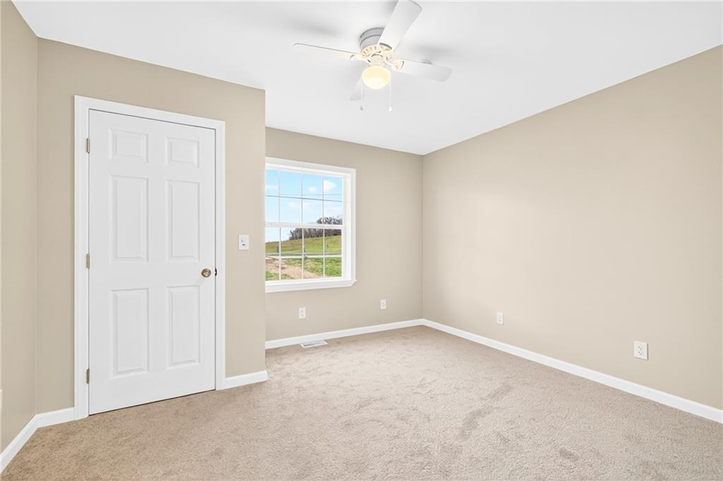 524 Sawmill Road Dawson, PA 15428 - Photo 35 of 50 an empty room with windows and ceiling fan