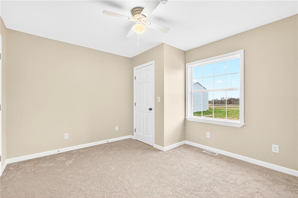 524 Sawmill Road Dawson, PA 15428 - Photo 36 of 50 an empty room with a window and a fan