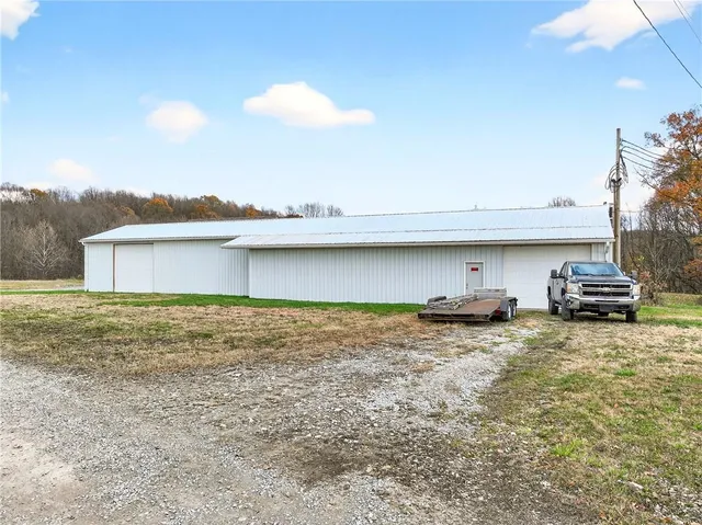 a view of a wooden house with a yard