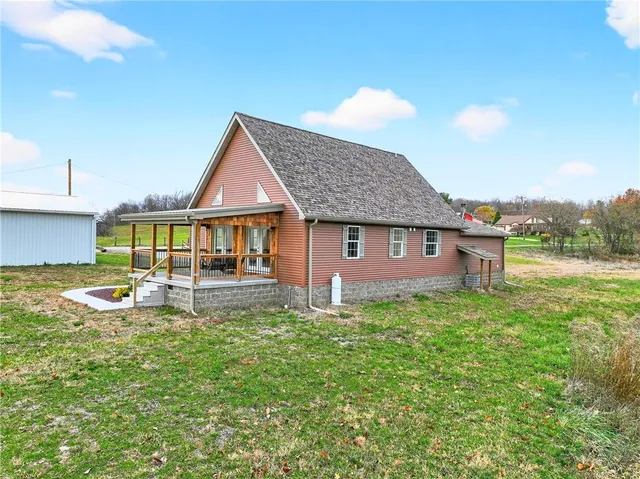 a view of a house with a yard and sitting area