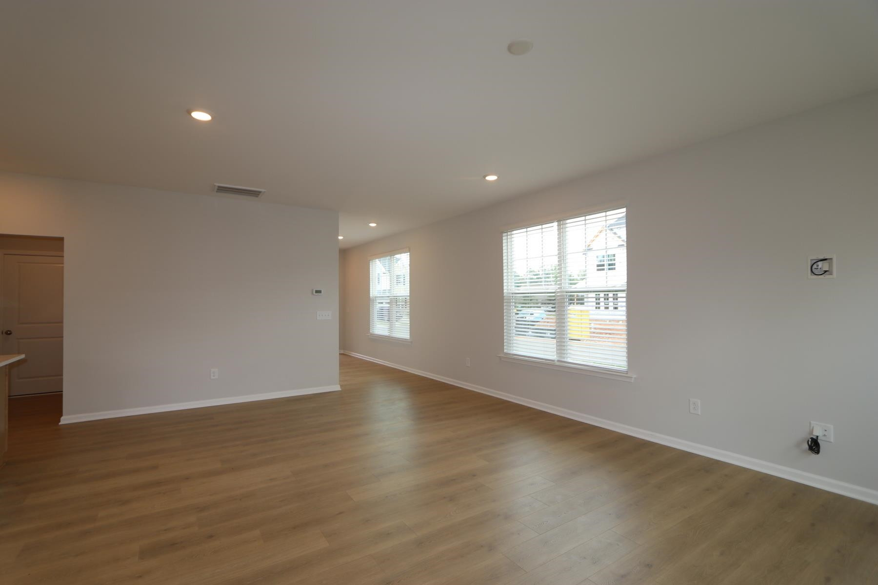 2106 Goudy Drive Raleigh, NC 27615 - Photo 18 of 24 an empty room with wooden floor and windows