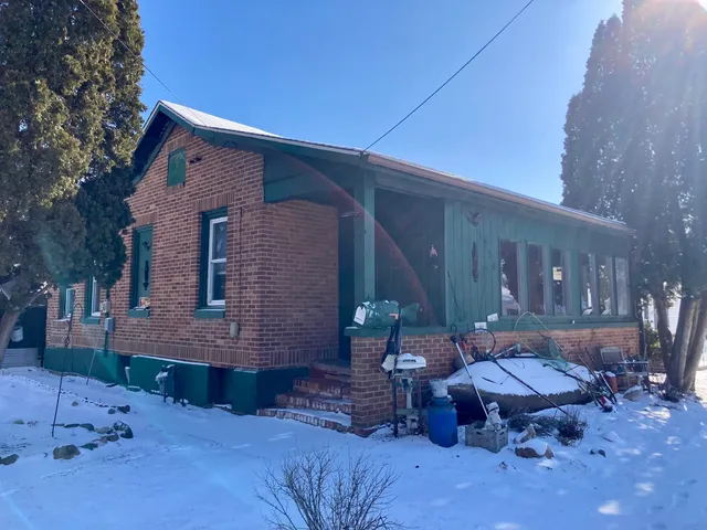 a backyard of a house with outdoor seating