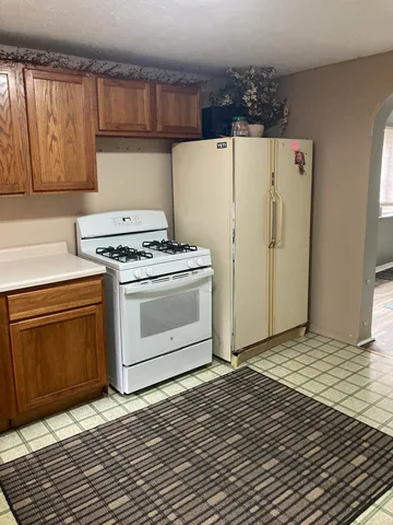 a kitchen with a stove top oven and cabinets