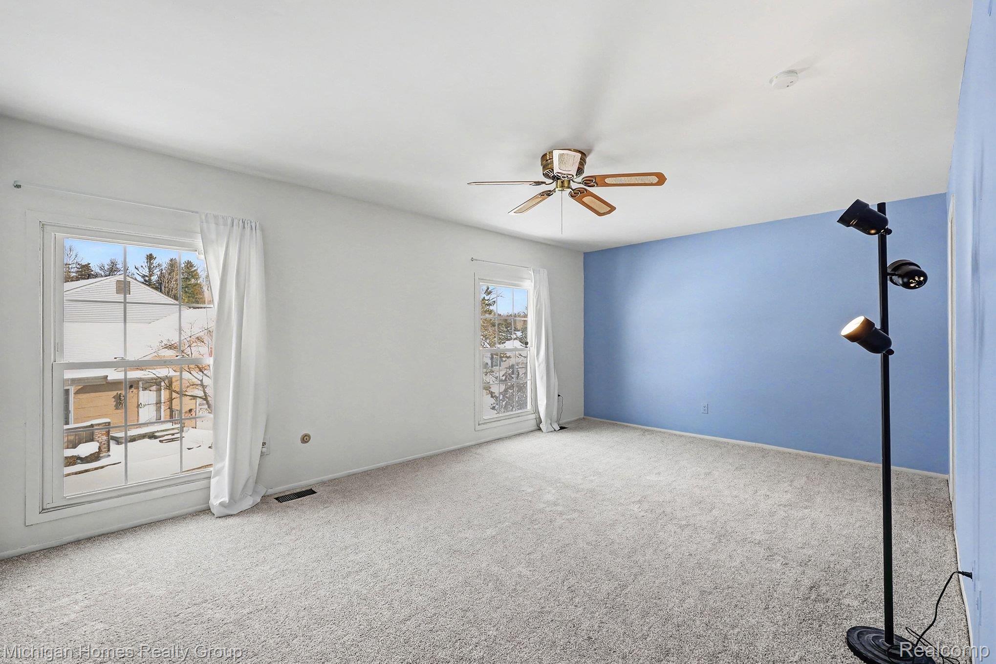 1437 Lantern Lane Rochester, MI 48306 - Photo 20 of 31 Carpeted spare room featuring a ceiling fan and baseboards