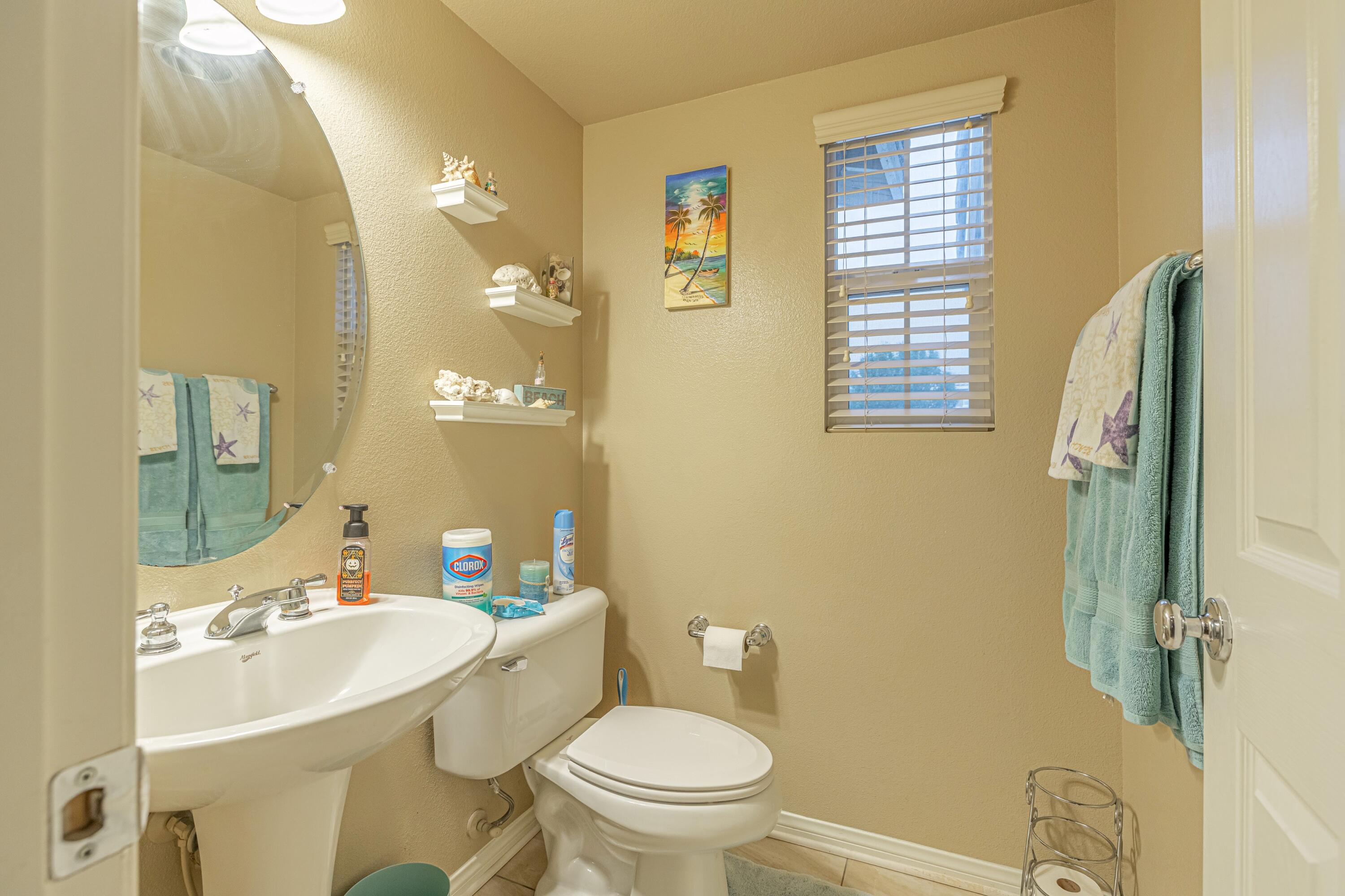 4403 Edam Street Lancaster, CA 93536 - Photo 22 of 42 a bathroom with a sink a toilet a mirror and shower
