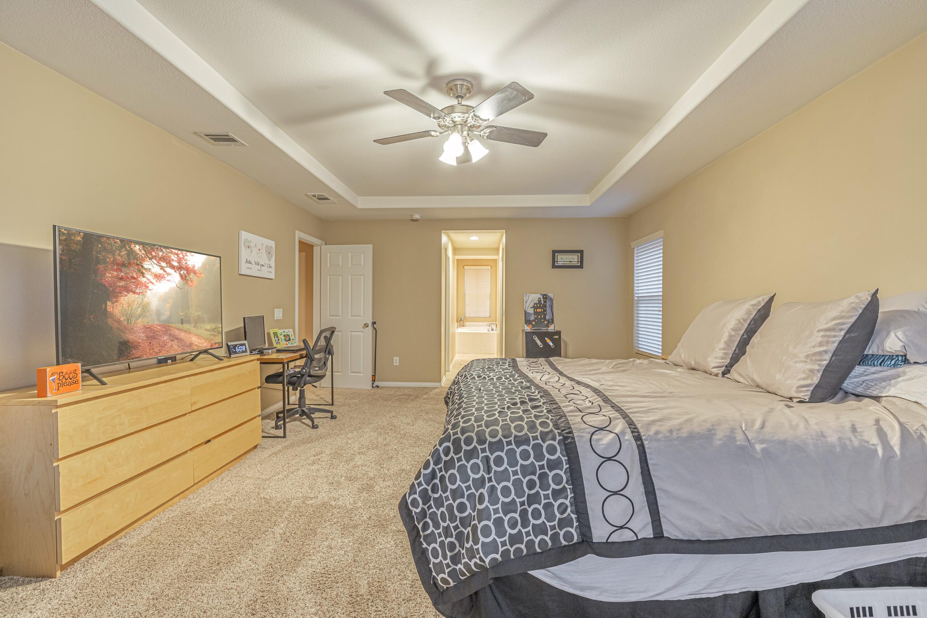 4403 Edam Street Lancaster, CA 93536 - Photo 24 of 42 a bed room with a bed and a chandelier