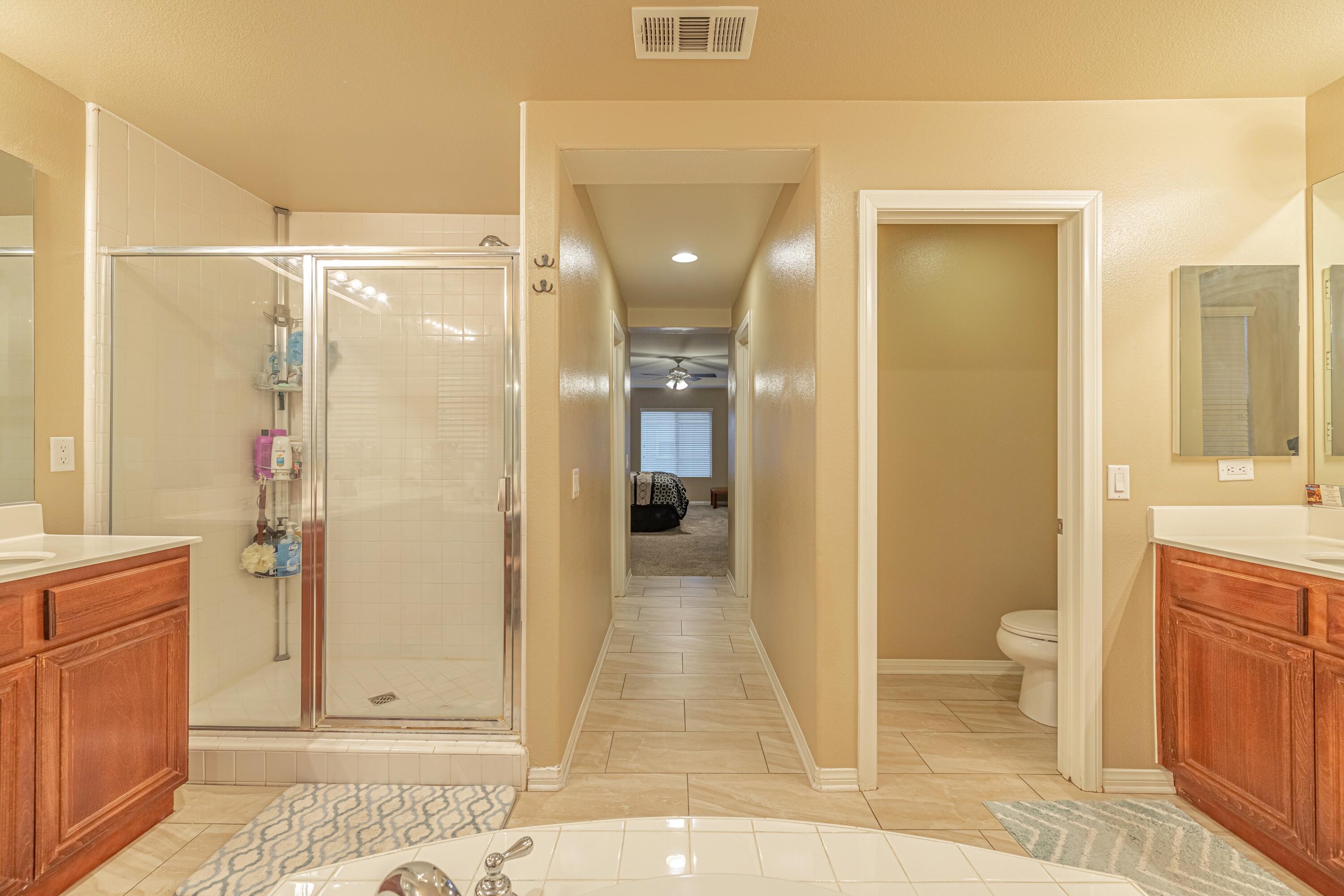 4403 Edam Street Lancaster, CA 93536 - Photo 26 of 42 a bathroom with a glass shower door and a sink