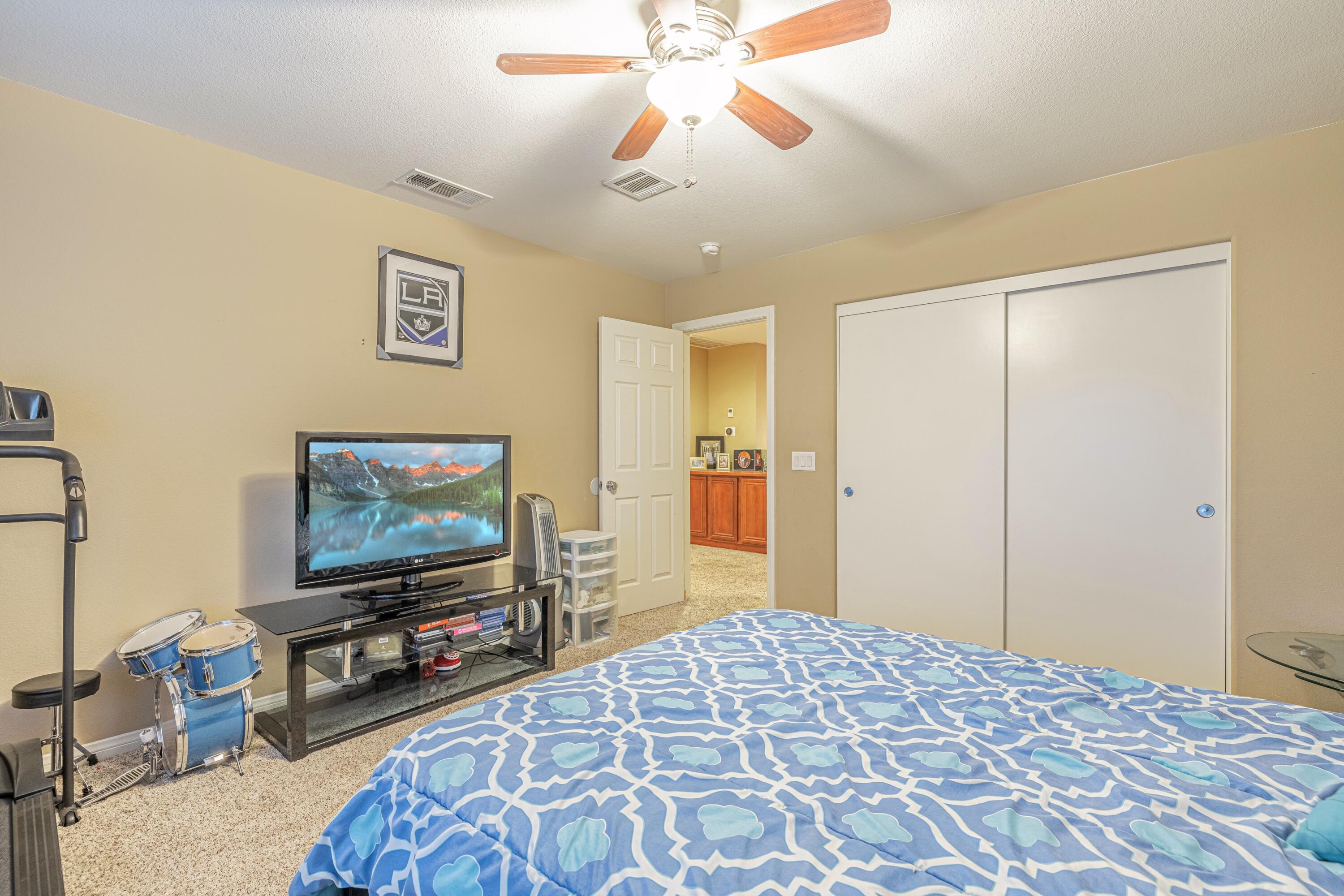 4403 Edam Street Lancaster, CA 93536 - Photo 31 of 42 a bedroom with a bed and a flat screen tv