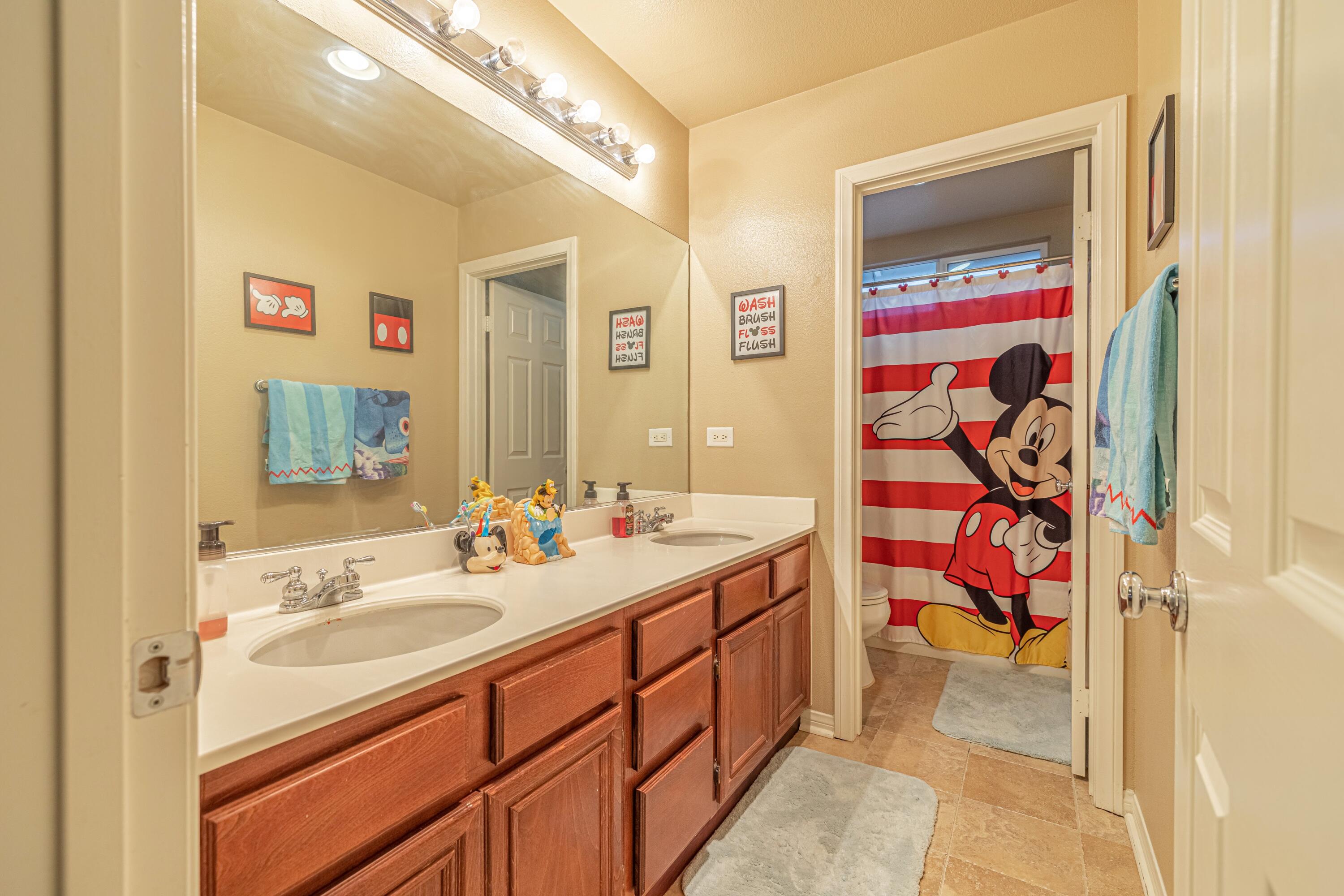 4403 Edam Street Lancaster, CA 93536 - Photo 32 of 42 a bathroom with a sink and a mirror