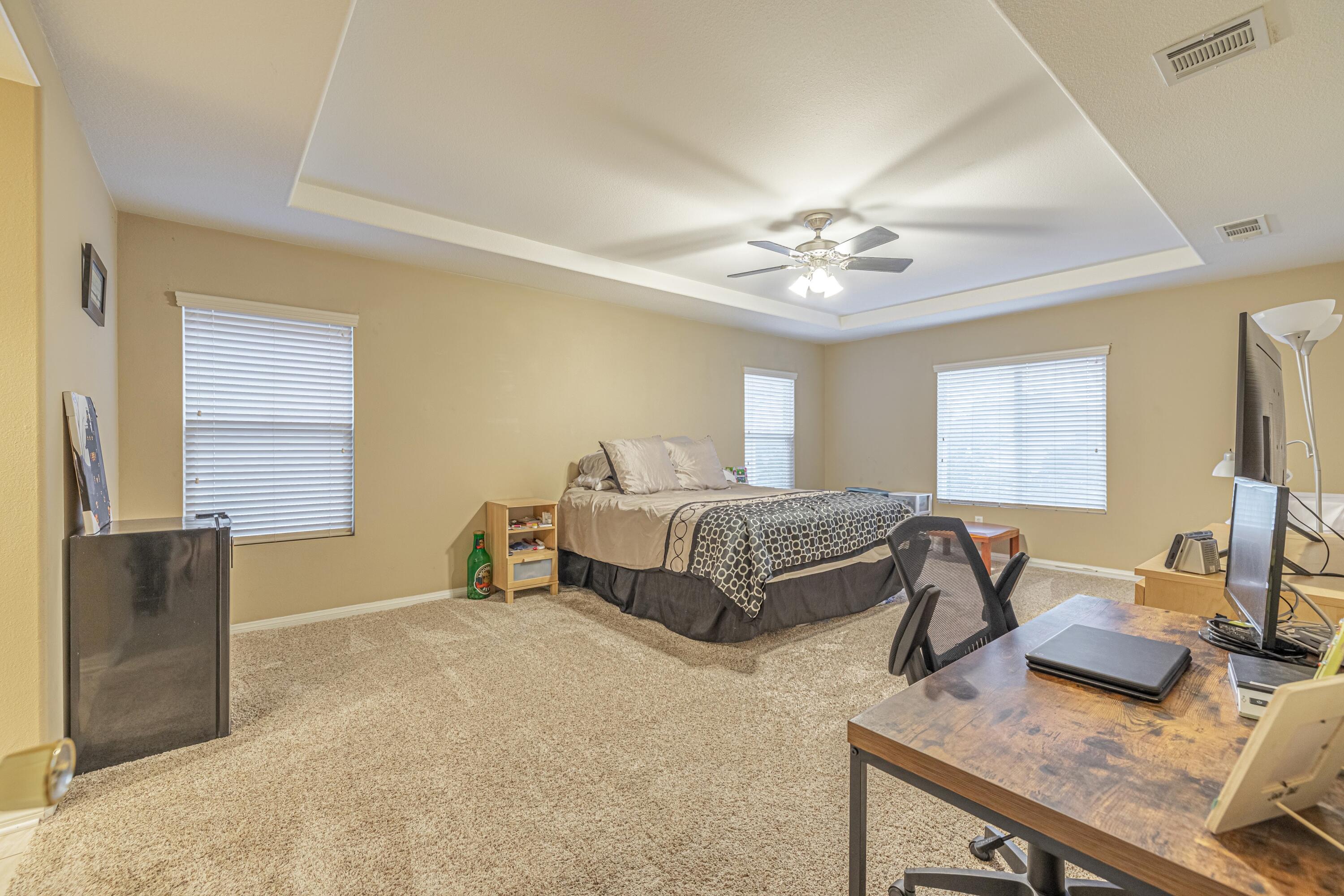 4403 Edam Street Lancaster, CA 93536 - Photo 5 of 42 a bedroom with a bed and a chandelier