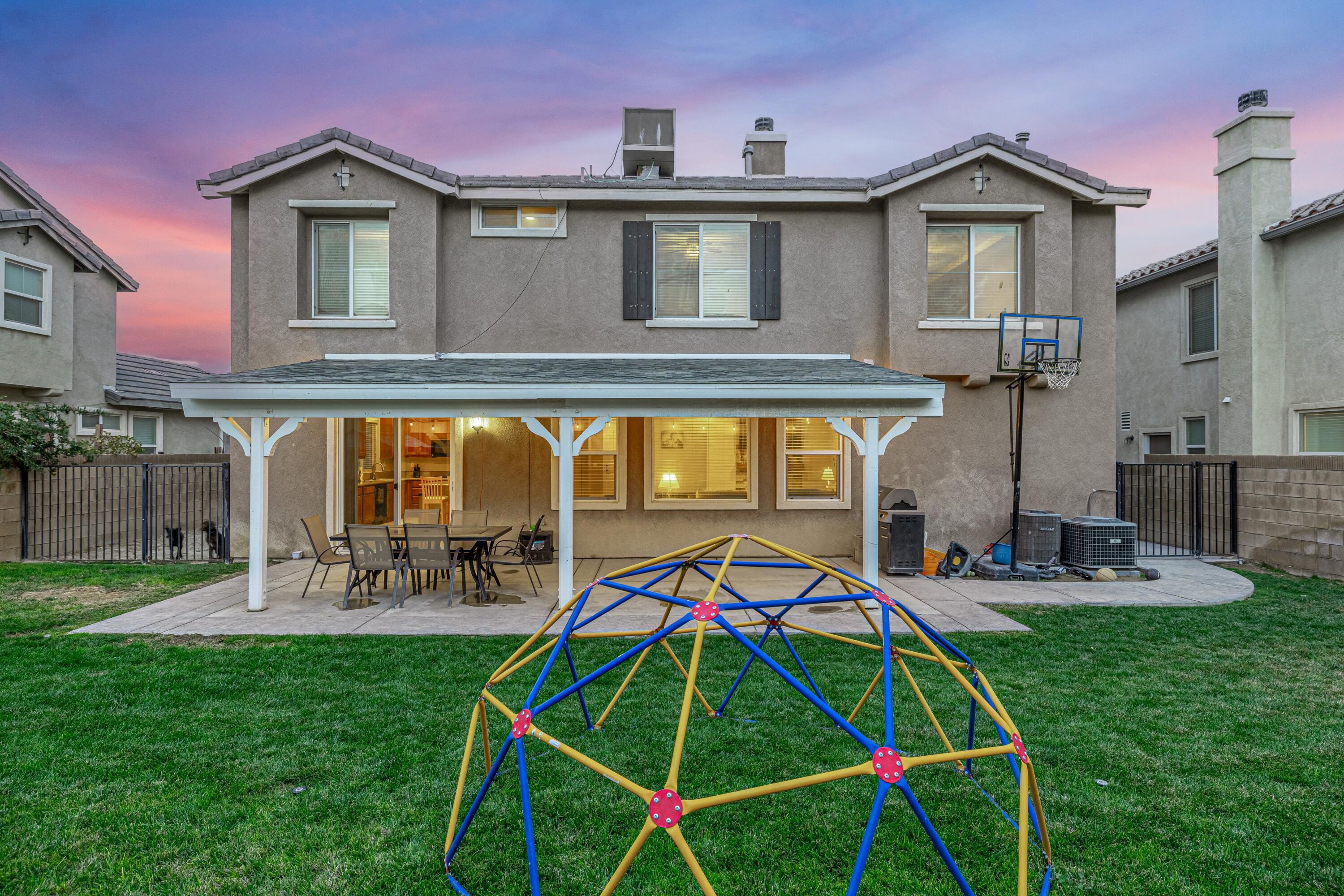 4403 Edam Street Lancaster, CA 93536 - Photo 41 of 42 a backyard of a house with table and chairs