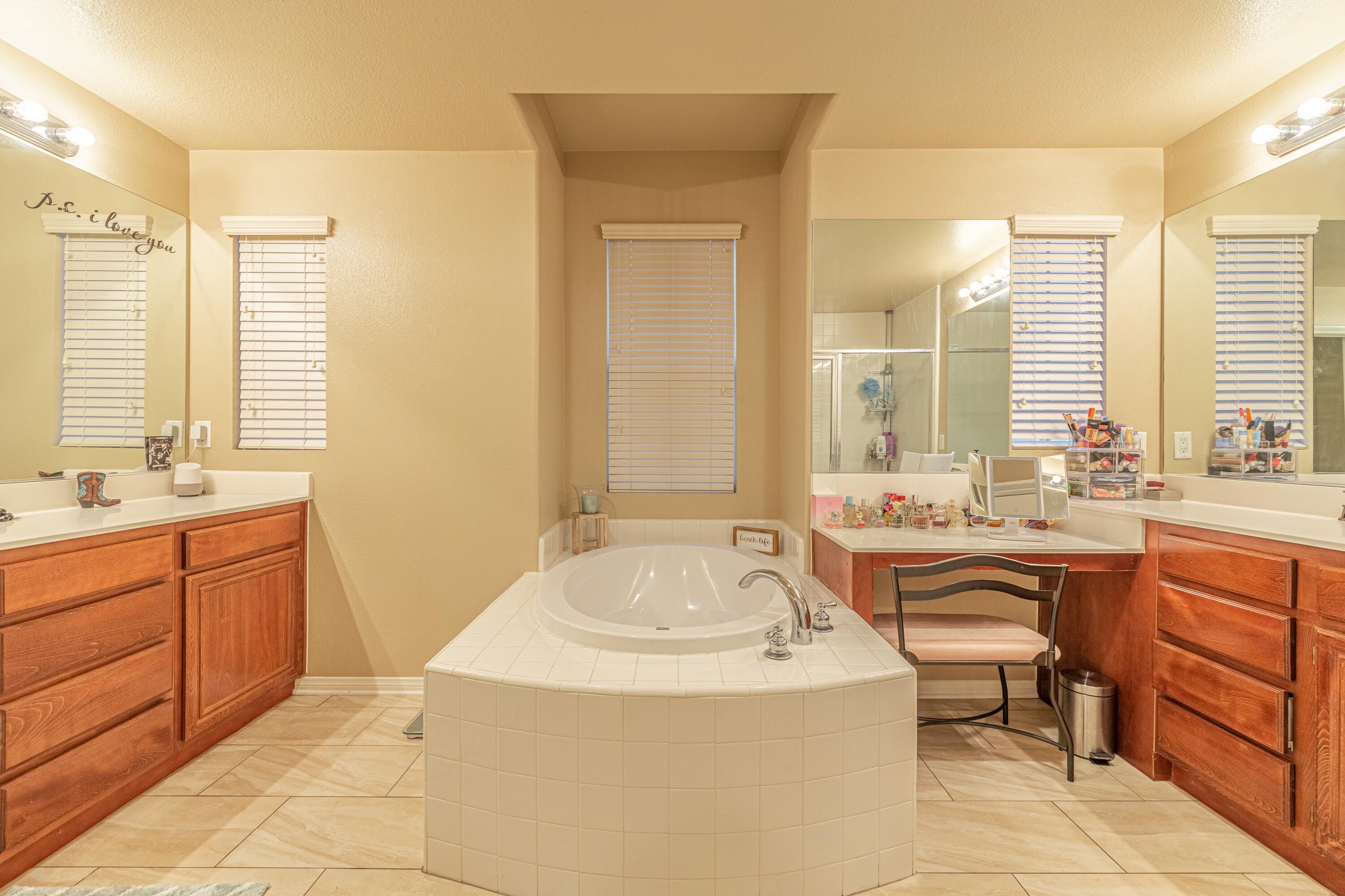 4403 Edam Street Lancaster, CA 93536 - Photo 6 of 42 a bathroom with a granite countertop sink and a bathtub