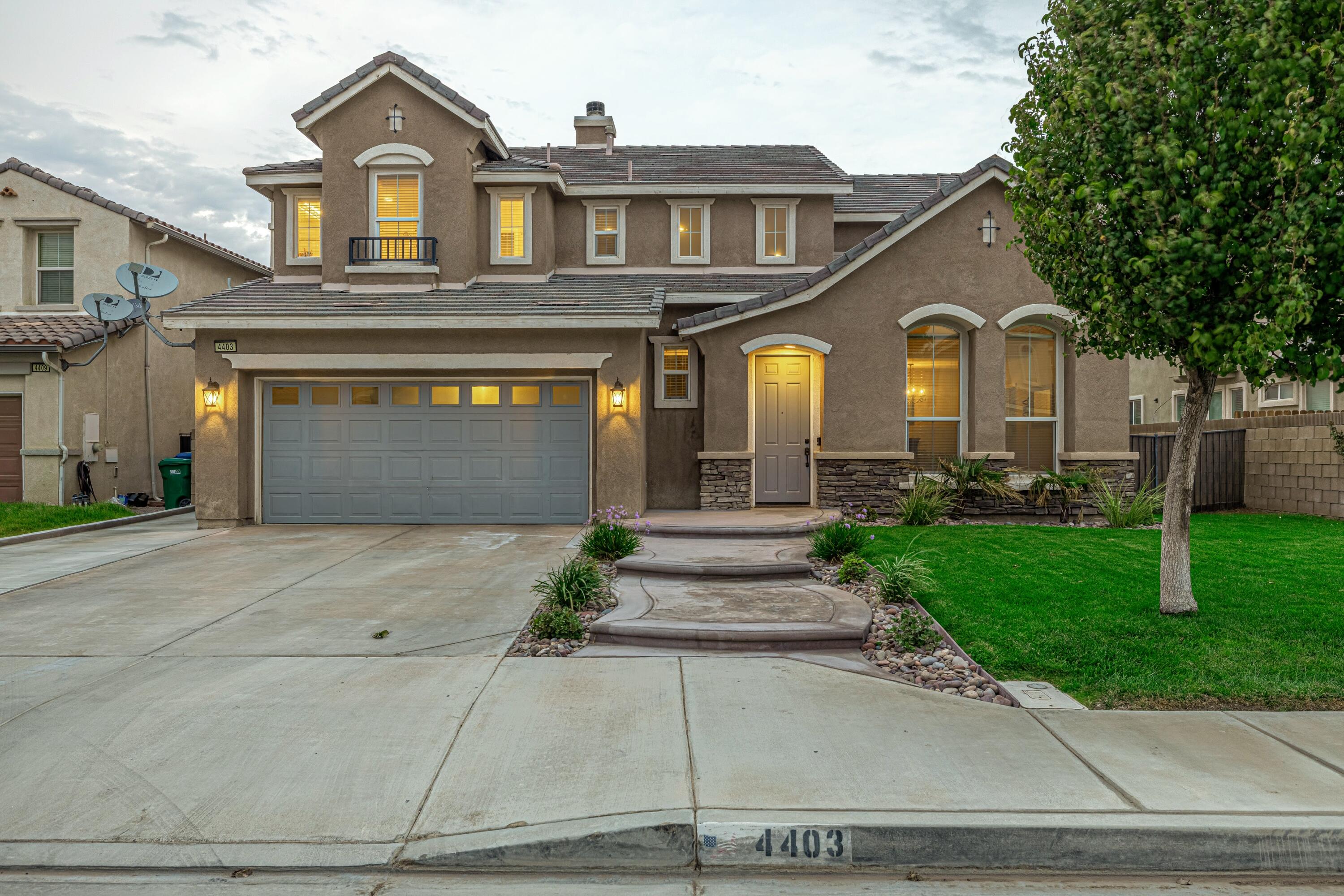 4403 Edam Street Lancaster, CA 93536 - Photo 9 of 42 a front view of a house with a yard and garage