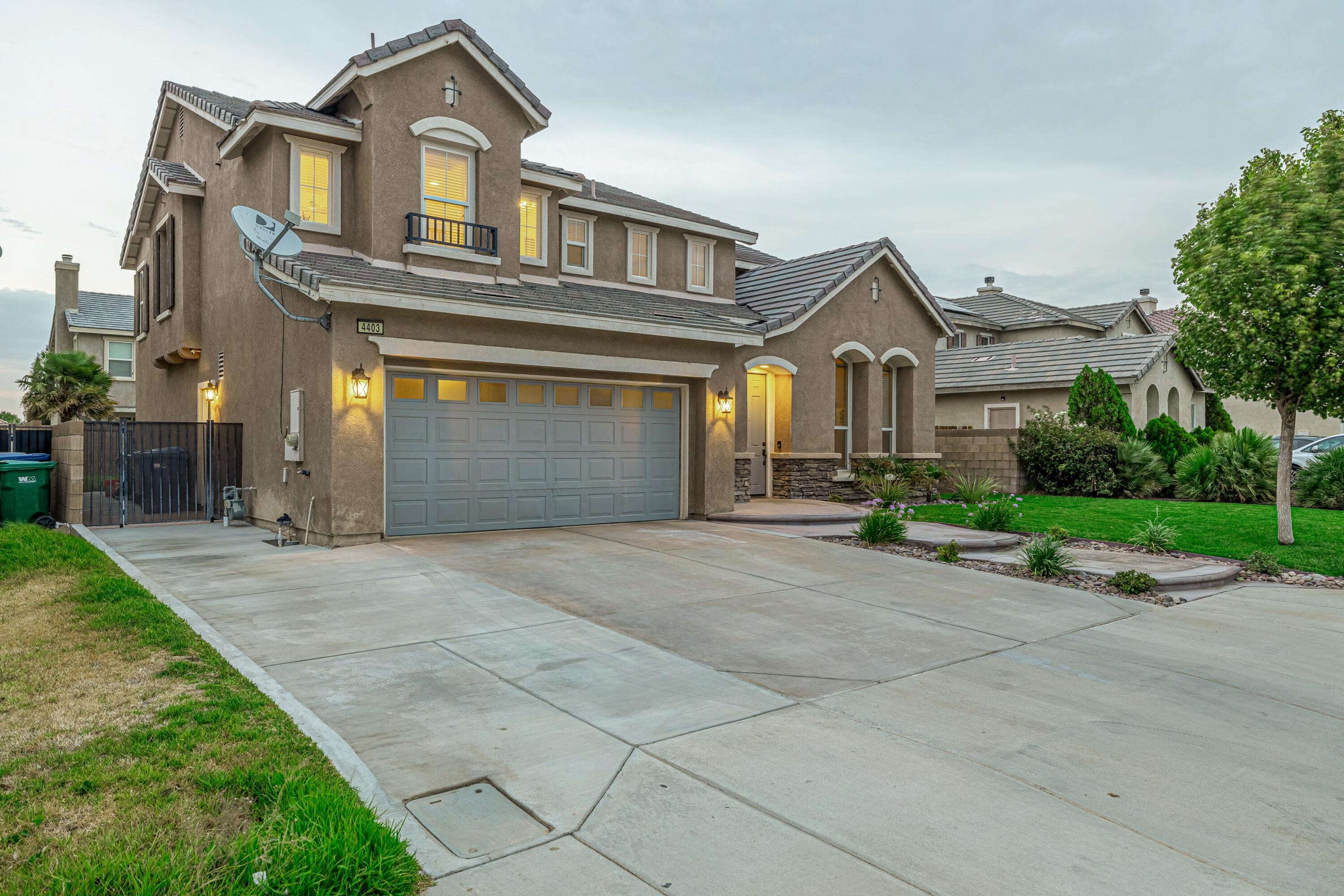 4403 Edam Street Lancaster, CA 93536 - Photo 10 of 42 a front view of a house with a yard and garage