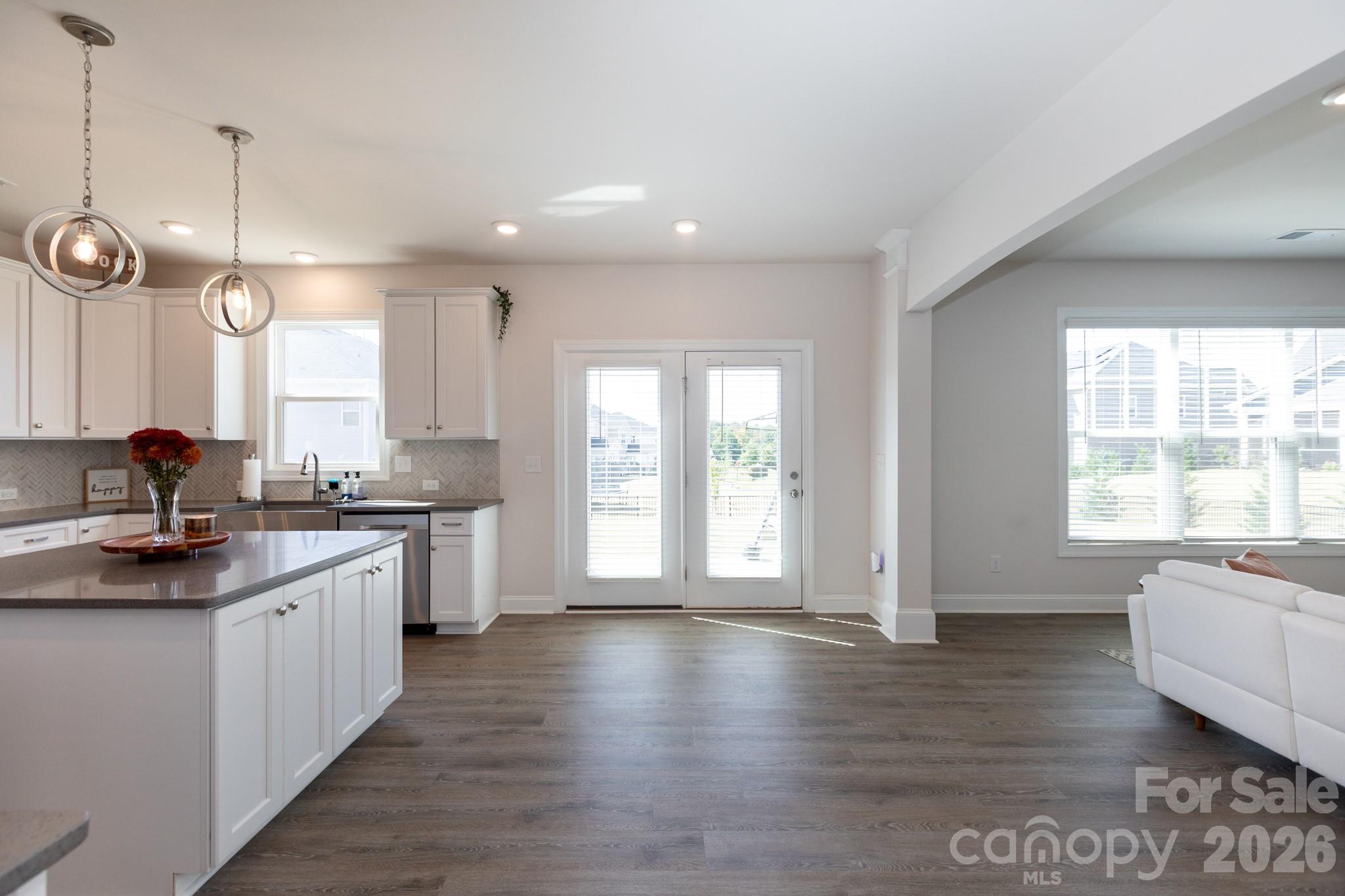 5415 Haystack Avenue Indian Land, SC 29707 - Photo 12 of 44 a large kitchen with stainless steel appliances granite countertop a stove a sink a center island and a window