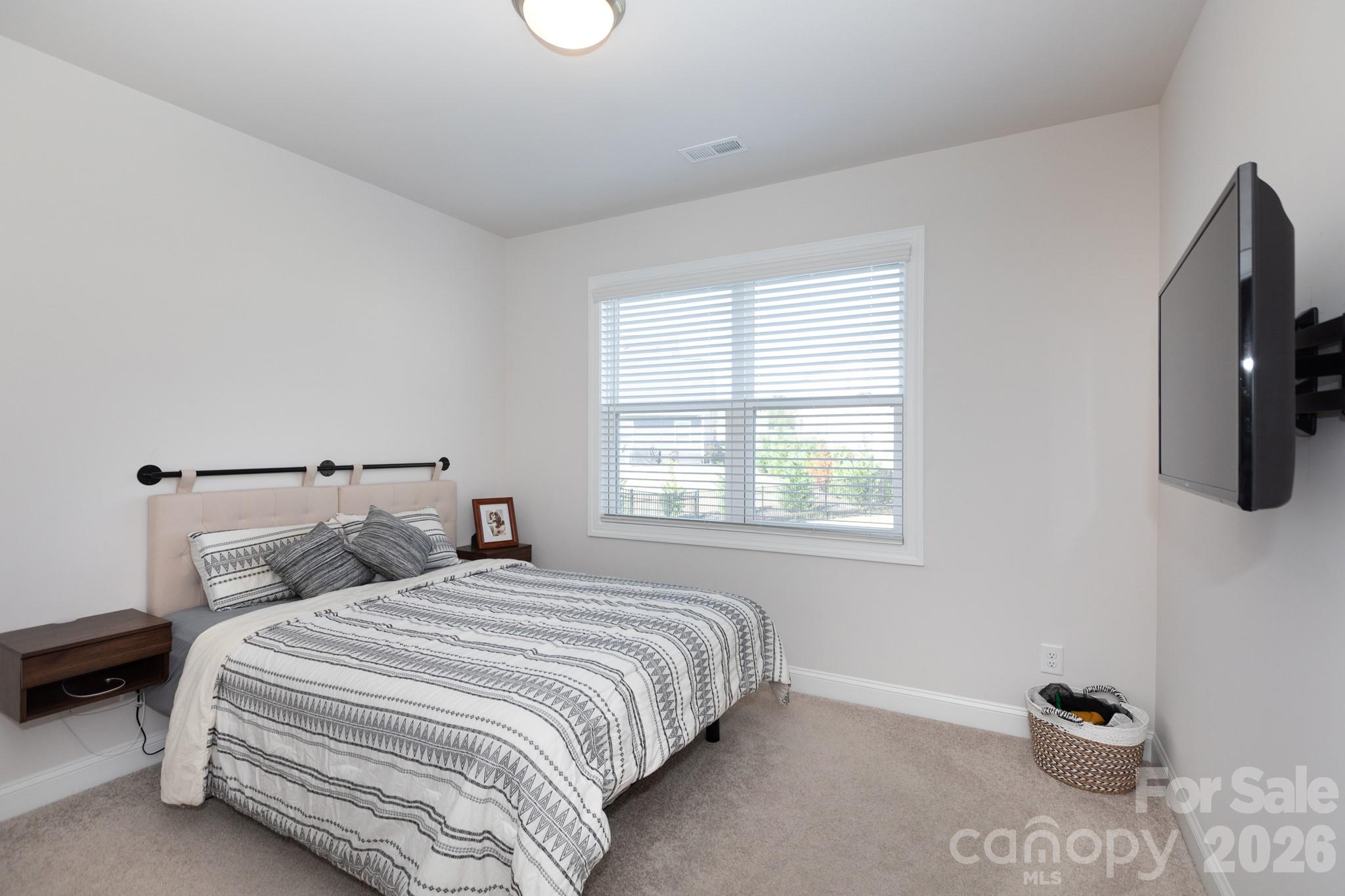 5415 Haystack Avenue Indian Land, SC 29707 - Photo 15 of 44 a bedroom with bed tv and window
