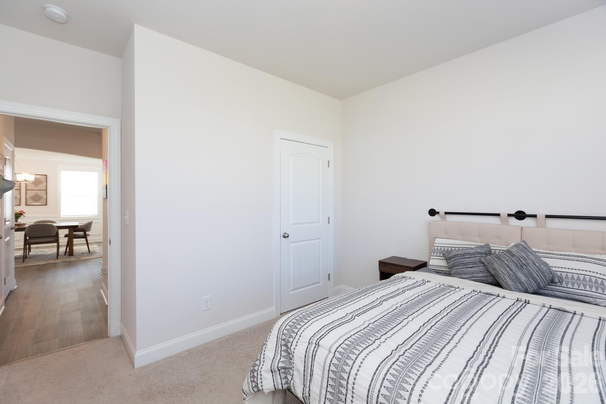 5415 Haystack Avenue Indian Land, SC 29707 - Photo 16 of 44 a bedroom with a bed and a large mirror