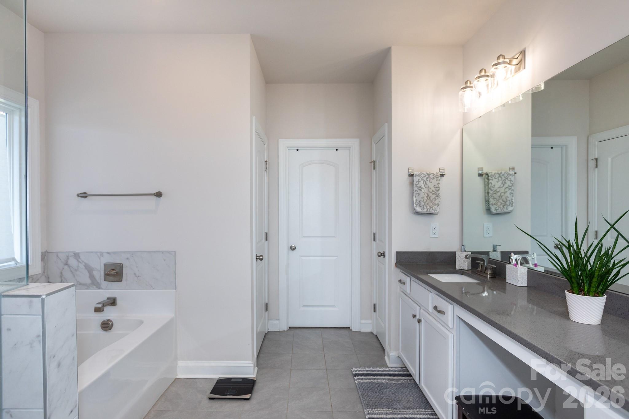 5415 Haystack Avenue Indian Land, SC 29707 - Photo 23 of 44 a spacious bathroom with a tub sink and mirror