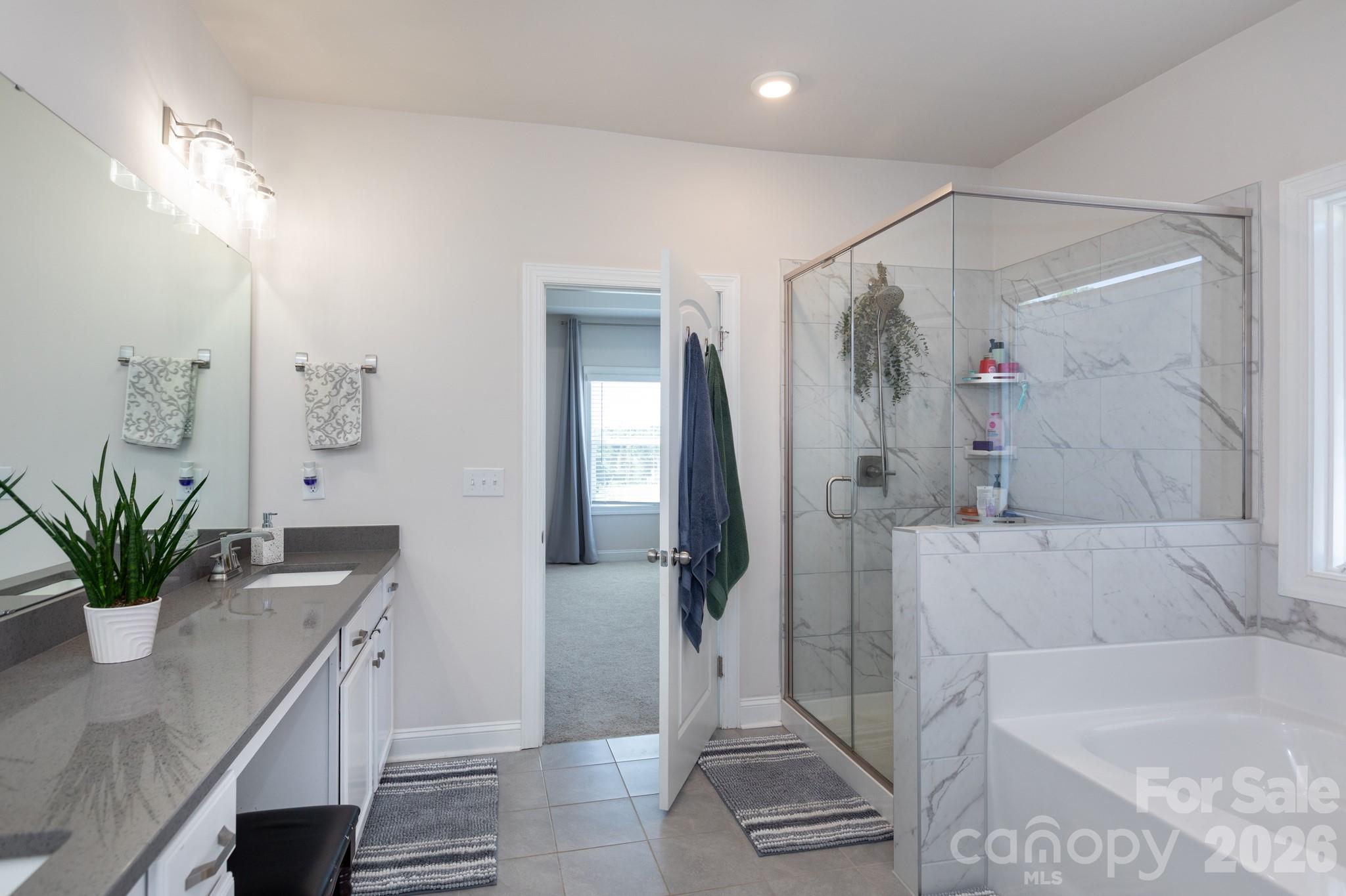 5415 Haystack Avenue Indian Land, SC 29707 - Photo 26 of 44 a bathroom with a granite countertop tub a potted plant and a shower