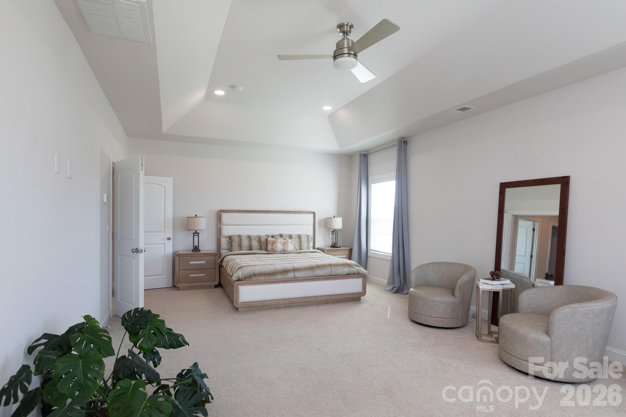 5415 Haystack Avenue Indian Land, SC 29707 - Photo 27 of 44 a spacious bedroom with a bed and a chandelier