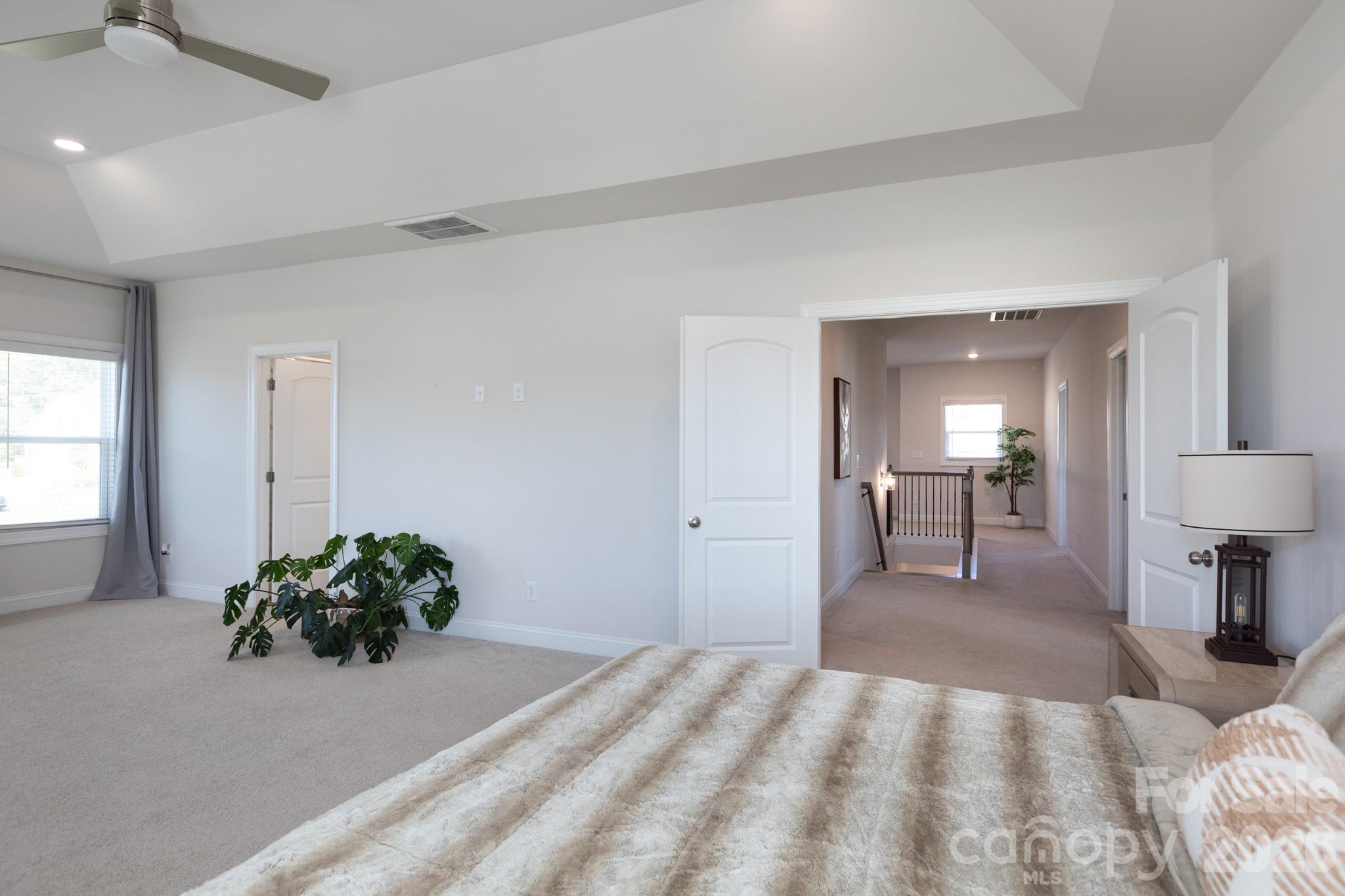 5415 Haystack Avenue Indian Land, SC 29707 - Photo 28 of 44 a bedroom with a bed and a potted plant