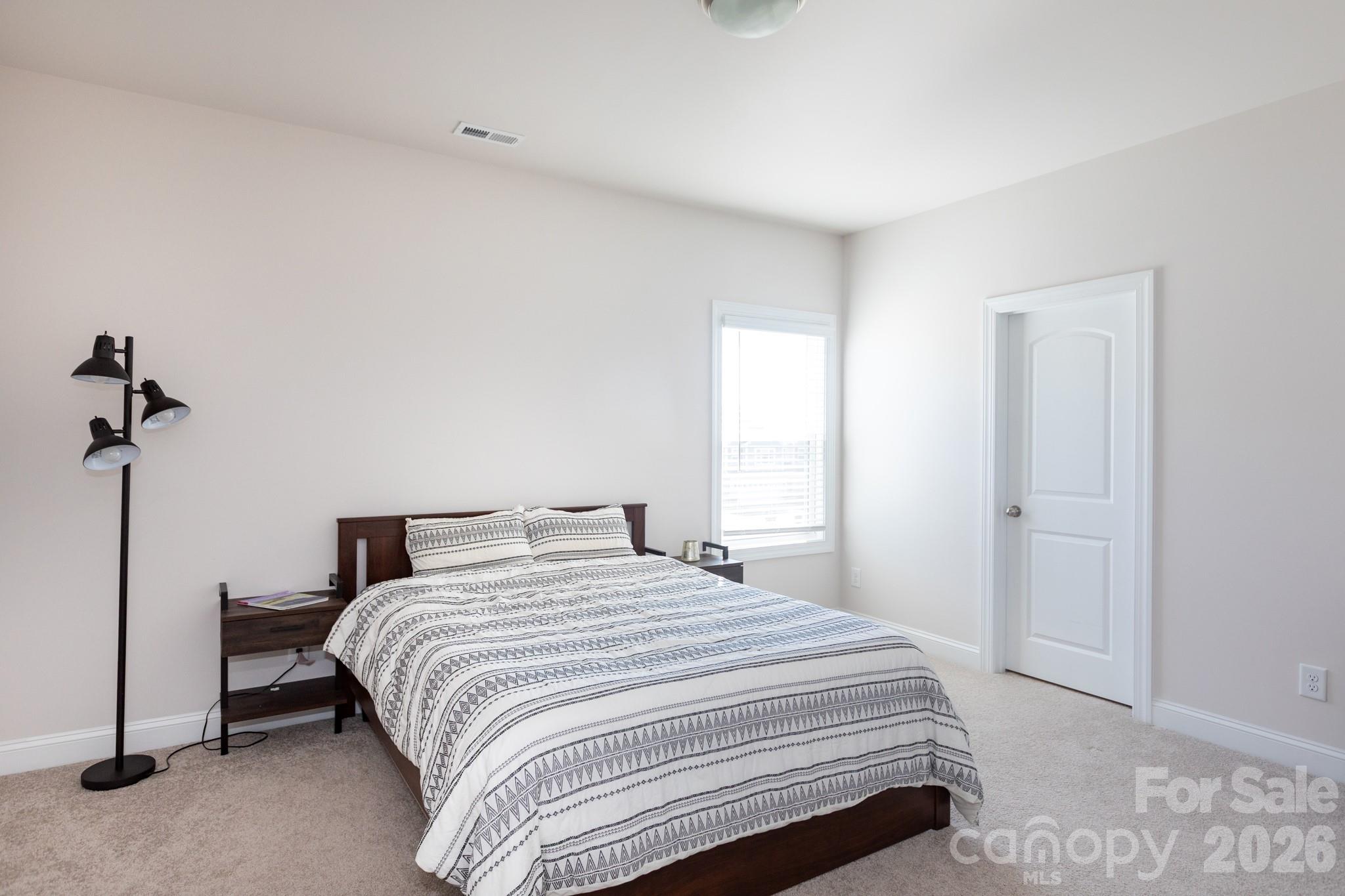 5415 Haystack Avenue Indian Land, SC 29707 - Photo 34 of 44 a bedroom with a bed and a night stand