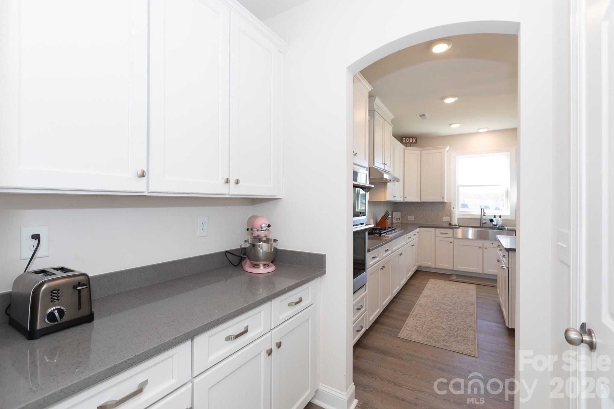 5415 Haystack Avenue Indian Land, SC 29707 - Photo 5 of 44 a kitchen with granite countertop white cabinets and stainless steel appliances
