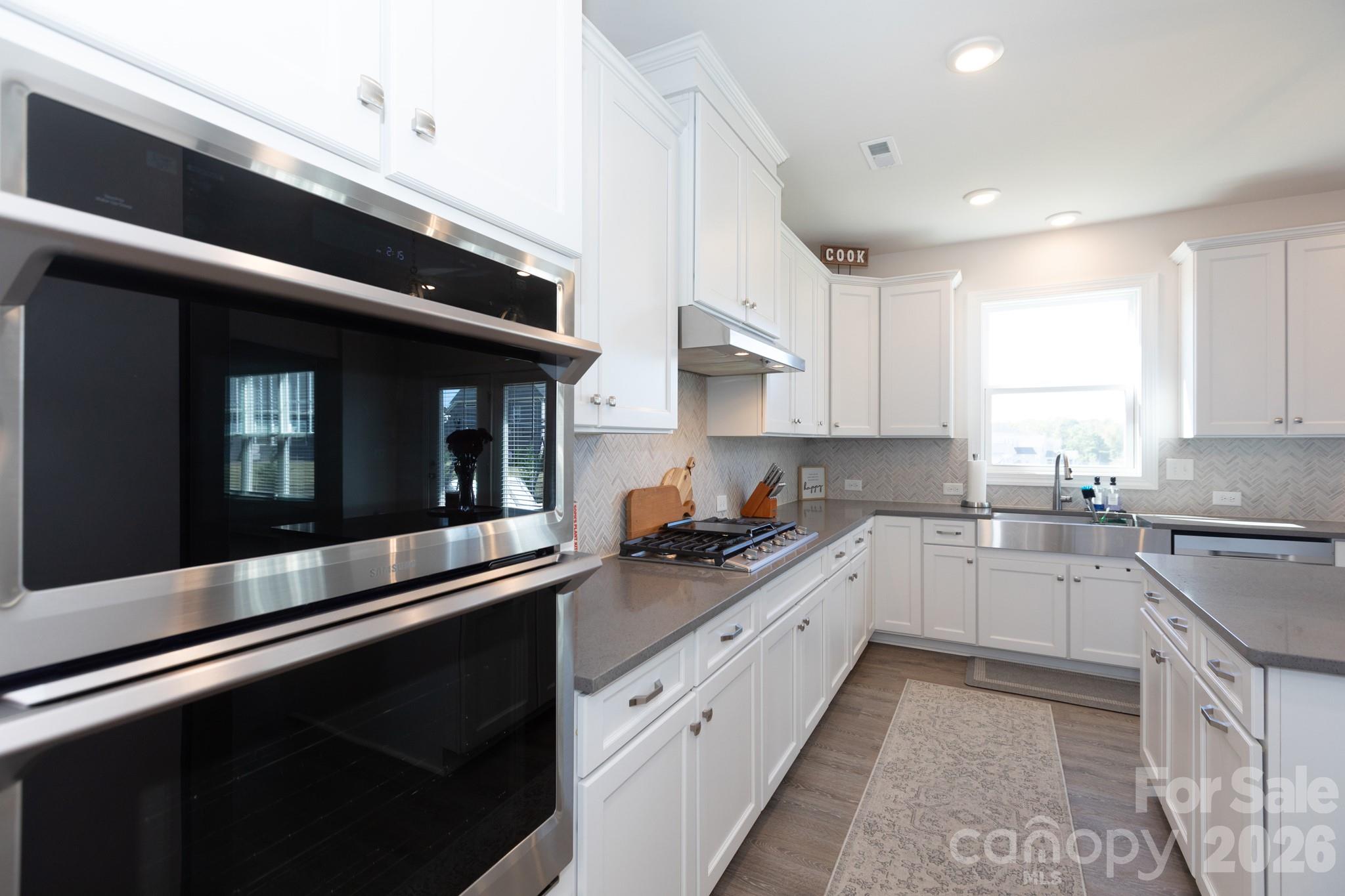 5415 Haystack Avenue Indian Land, SC 29707 - Photo 6 of 44 a kitchen with granite countertop white cabinets and white appliances