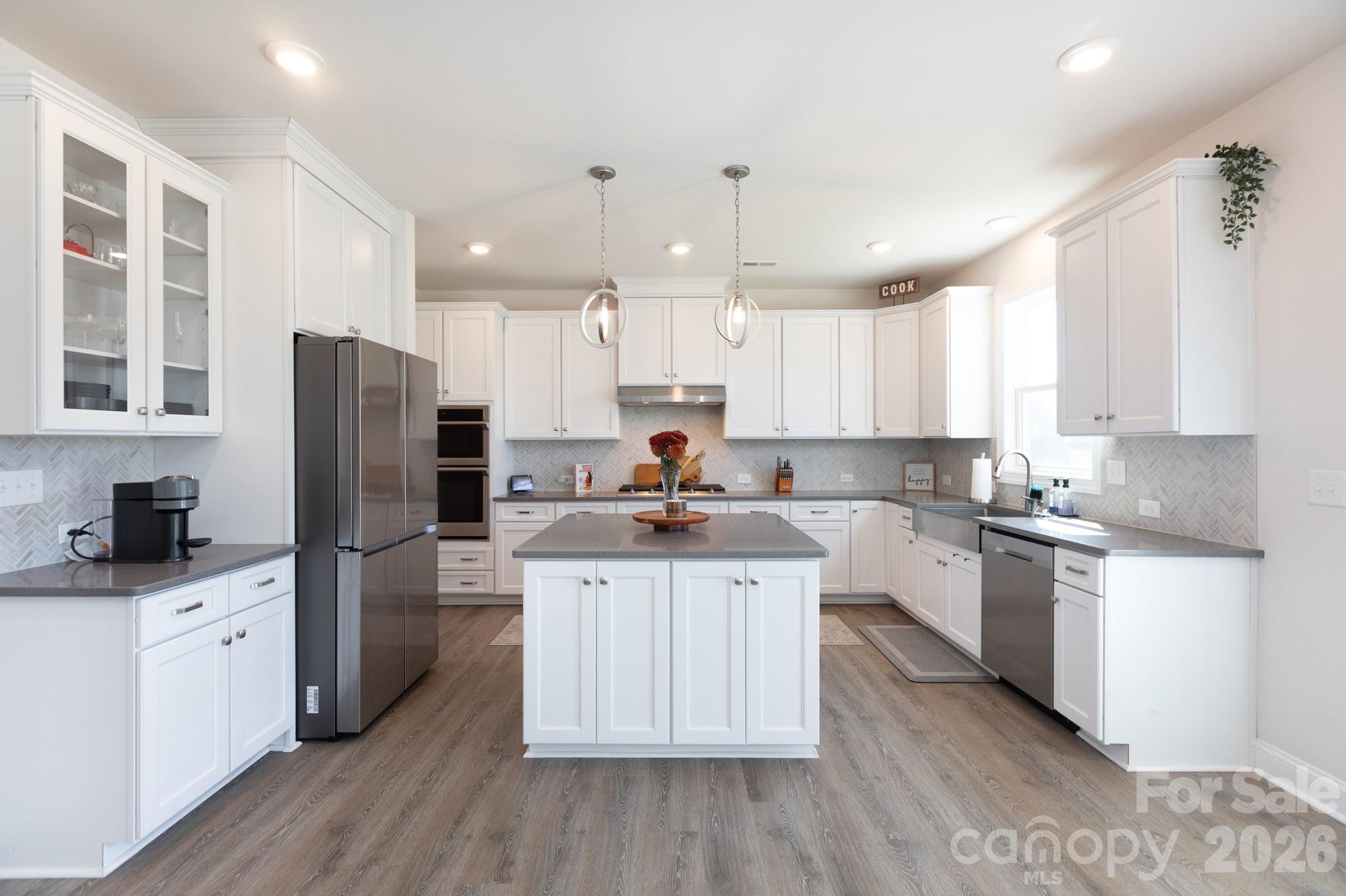 5415 Haystack Avenue Indian Land, SC 29707 - Photo 7 of 44 a kitchen with a sink a refrigerator a stove and white cabinets