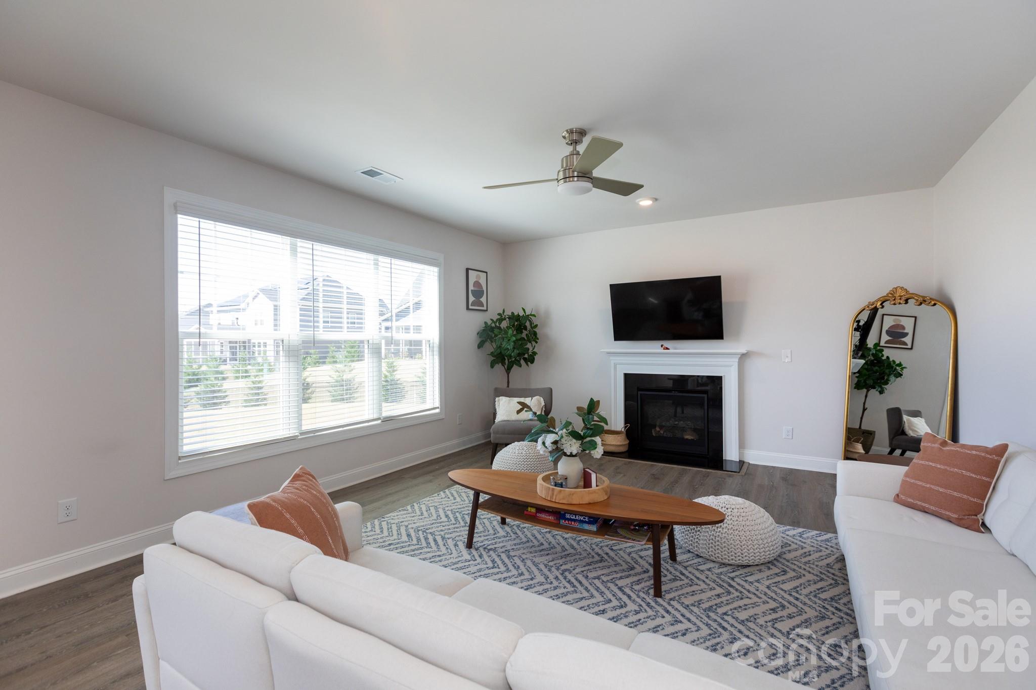 5415 Haystack Avenue Indian Land, SC 29707 - Photo 10 of 44 a living room with furniture a fireplace and a flat screen tv