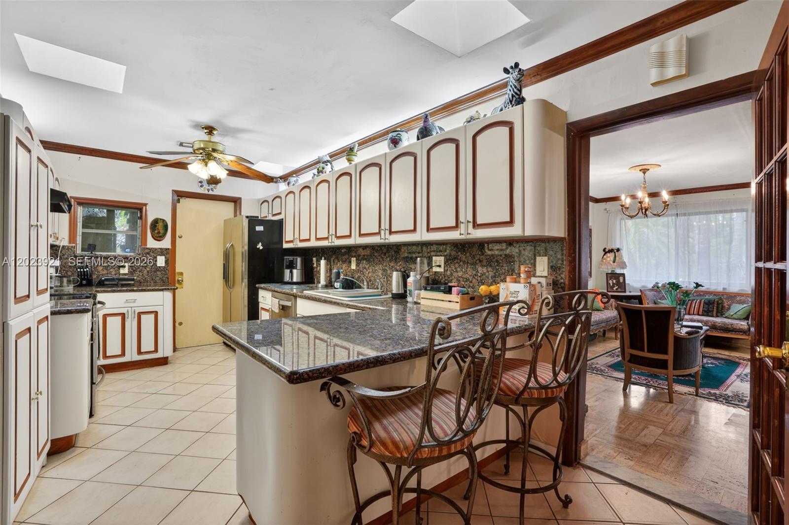 8461 Southwest 68th St Road Miami, FL 33143 - Photo 53 of 65 a kitchen with stainless steel appliances granite countertop a stove top oven a sink a dining table and chairs