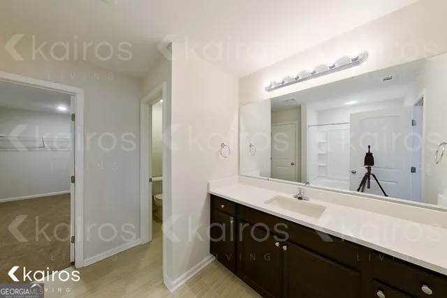 a bathroom with a double vanity sink and a mirror