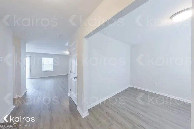 a view of an empty room and wooden floor