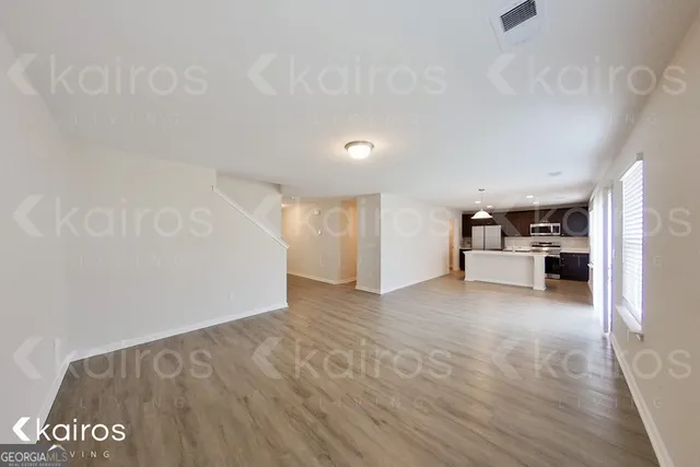 a view of a kitchen with a sink and a refrigerator