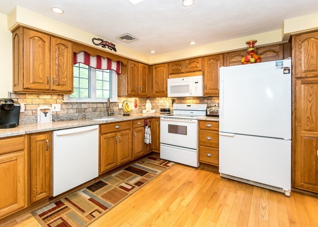 10 Carlin Road Waltham, MA 02451 - Photo 4 of 26 a kitchen with a refrigerator and a sink