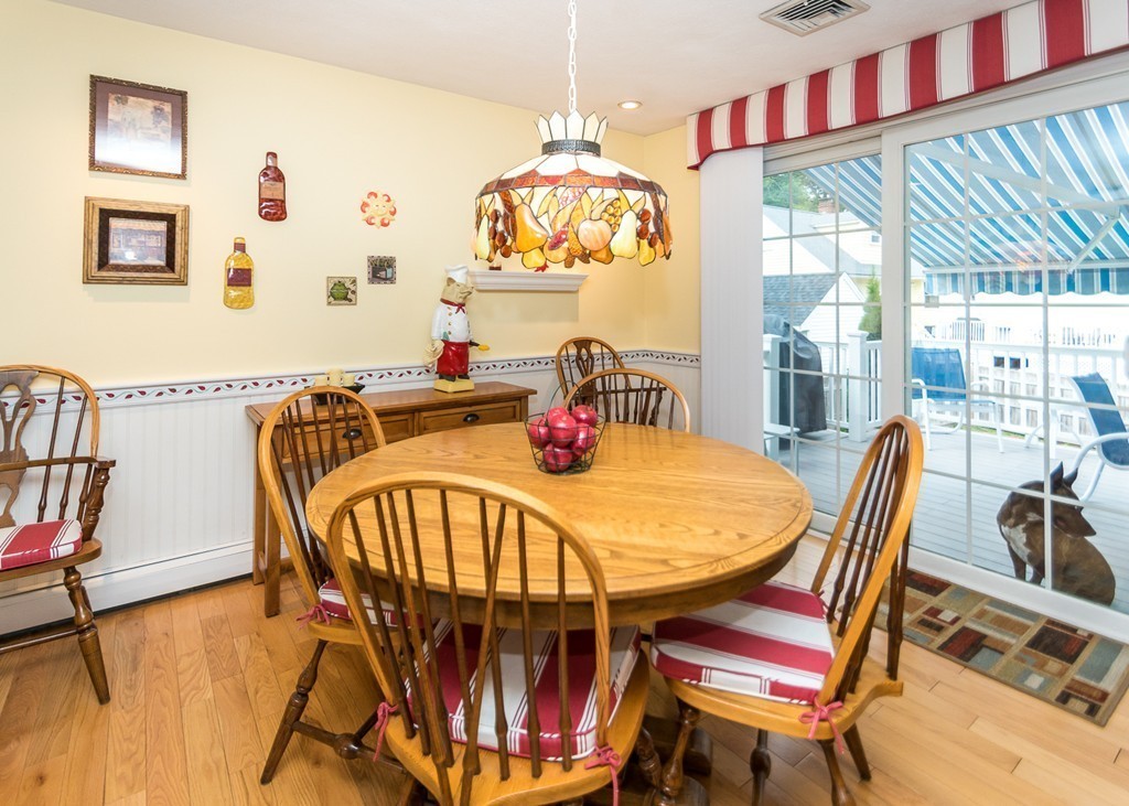 10 Carlin Road Waltham, MA 02451 - Photo 8 of 26 a dining room with furniture a chandelier and wooden floor