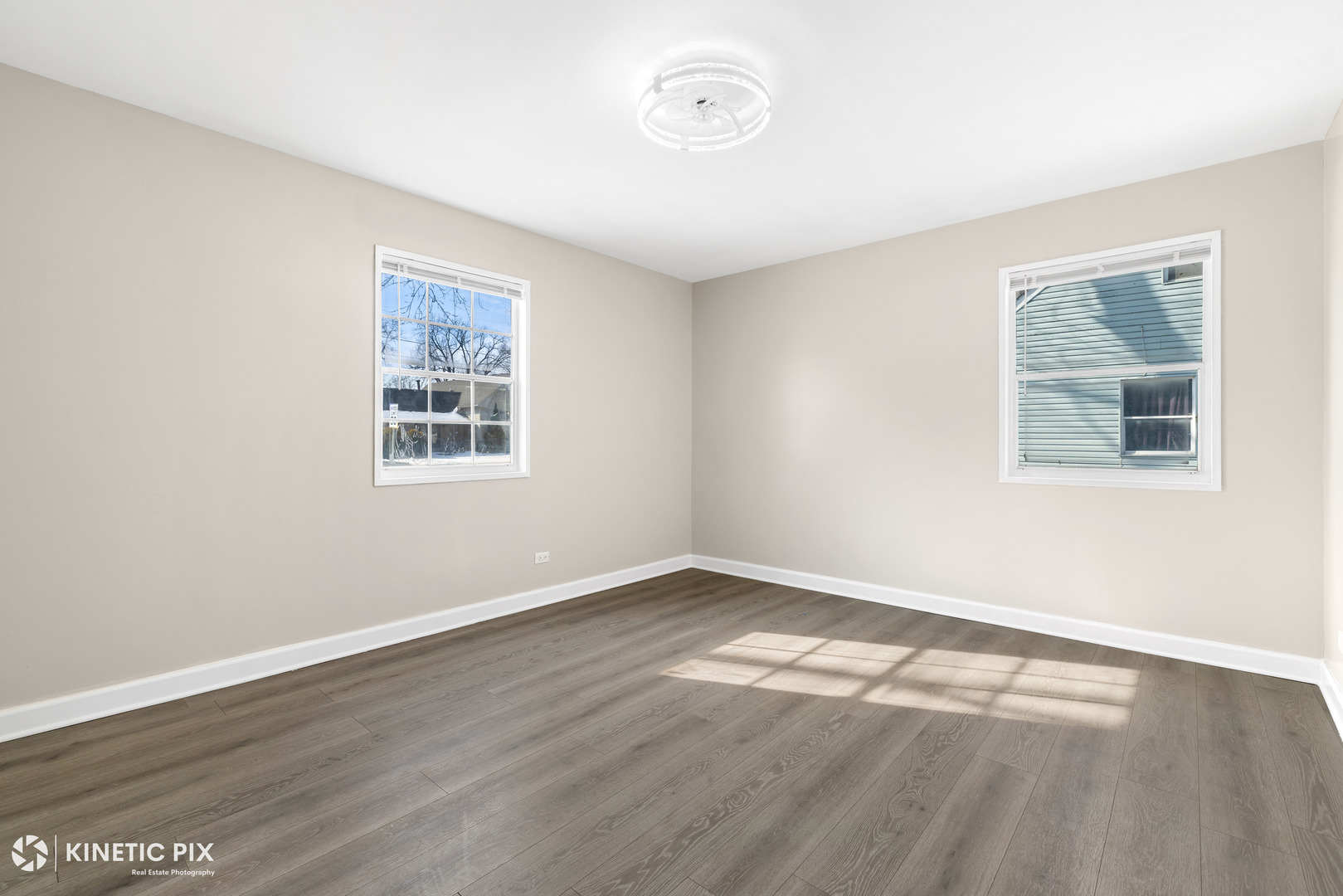 1412 West Broadview Avenue Crete, IL 60417 - Photo 12 of 28 an empty room with wooden floor and windows