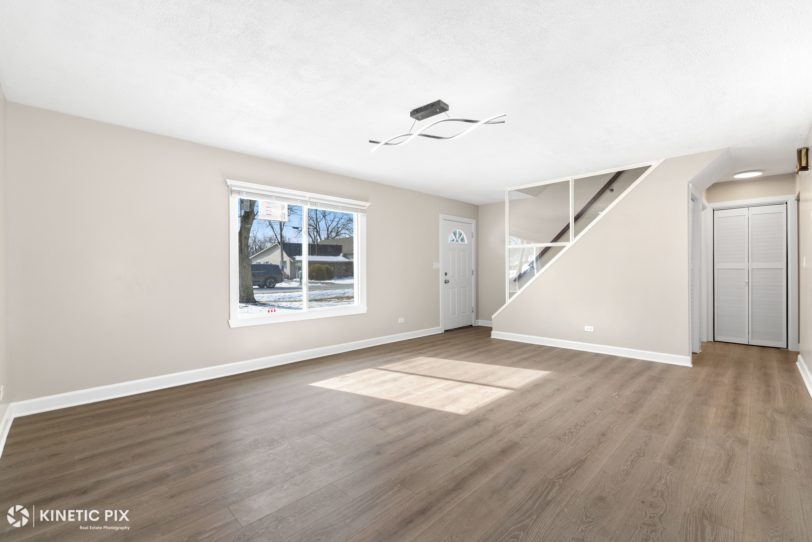 1412 West Broadview Avenue Crete, IL 60417 - Photo 6 of 28 a view of an empty room with wooden floor and a window