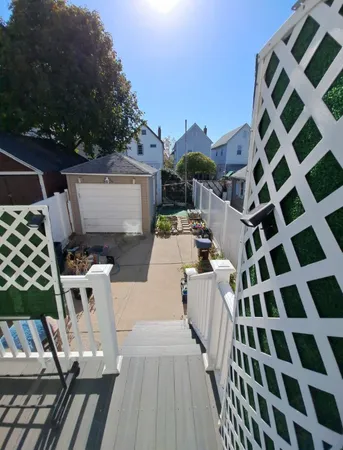 a view of a terrace with chairs and potted plants